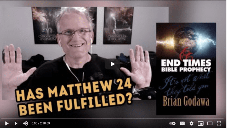 Smiling man raising hands beside Bible prophecy book